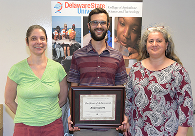 Brian Galvez (center) -- 1st place Graduate Oral Presentation, with Dr. Stacy Smith and Dr. Gulnihal Ozbay.