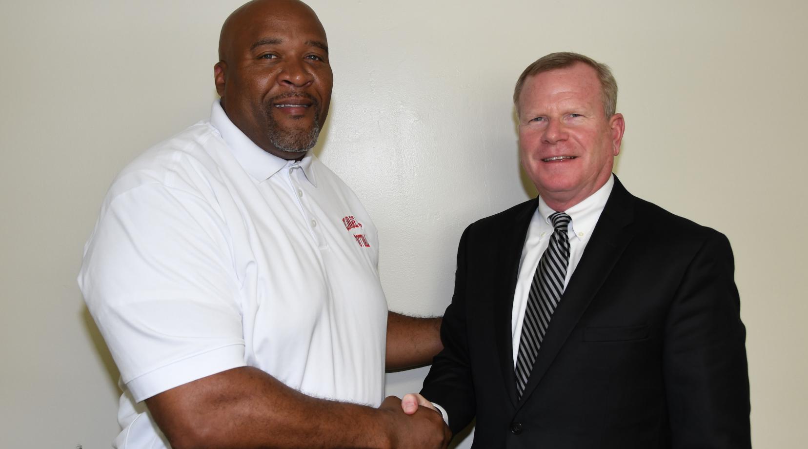 DSU Head Football Coach Rod Milstead welcomes his new boss (r) Dr. D. Scott Gines, who has been newly named the University's Athletic Director.