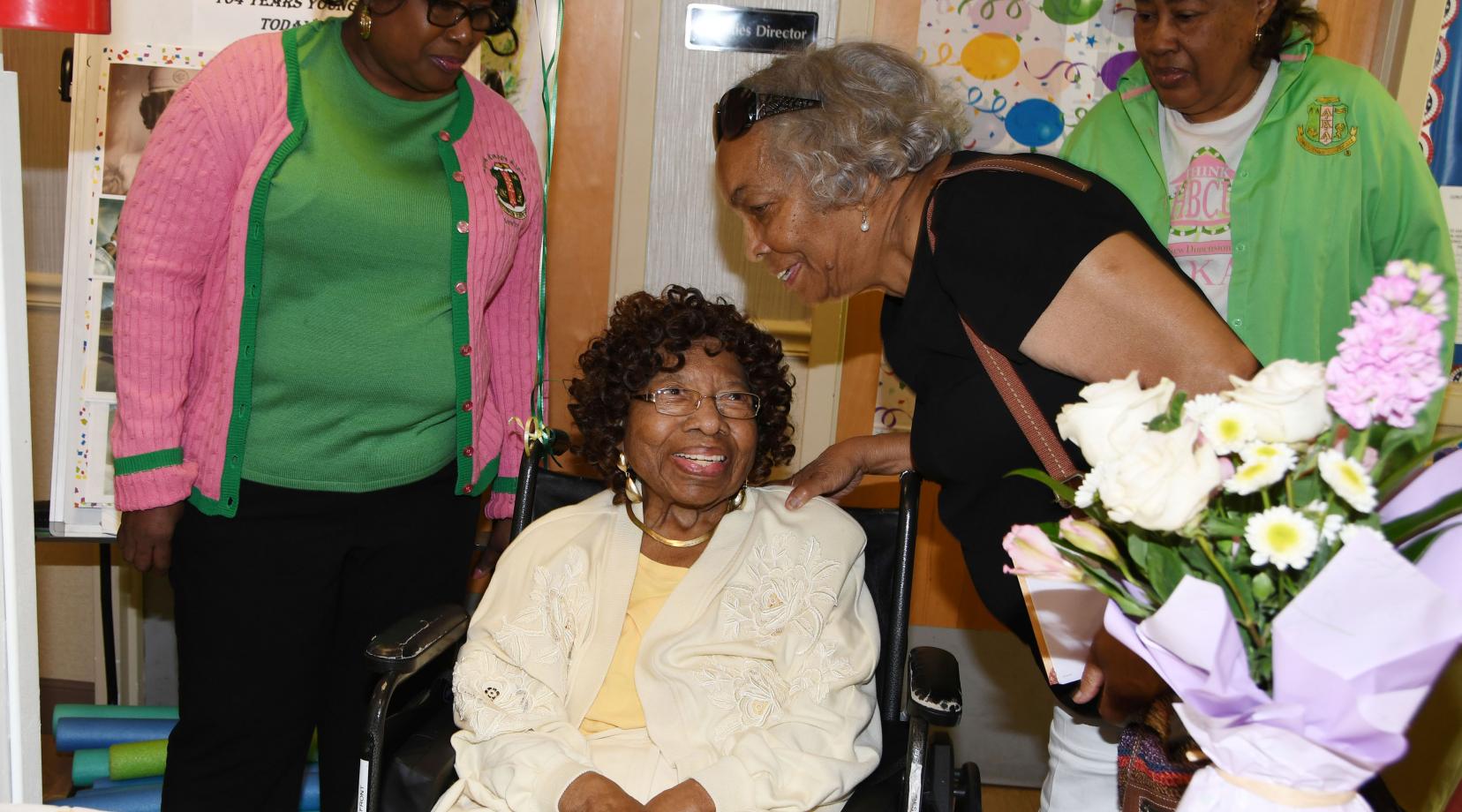 Courtney Stevenson (seated) talks with AKA sorority sister Peggy Swygert at her 104th birthday celebration at the Capital Rehabilitation Center where she lives.