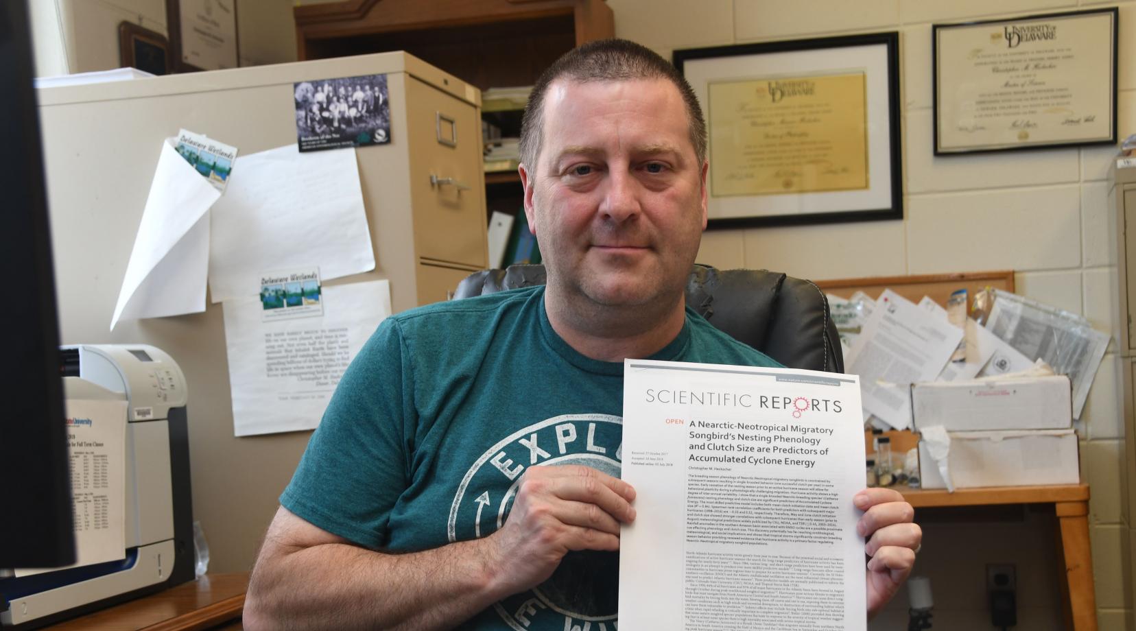 Dr. Christopher Heckscher shows the paper he has published on the relationship between Veery breeding length and hurricane season severity.