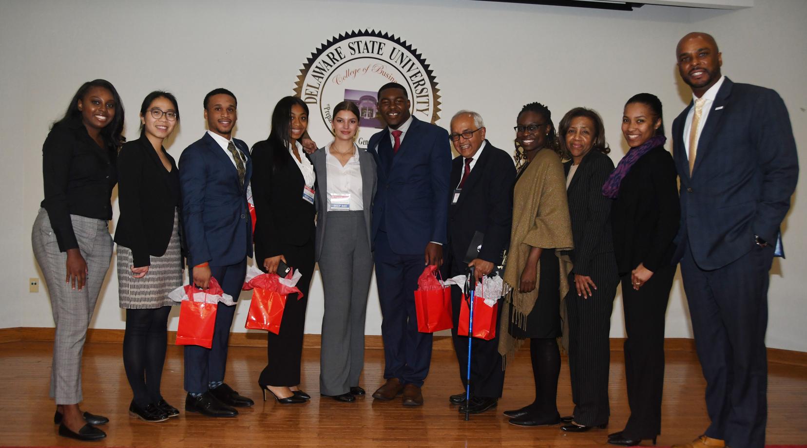 The Gates visitors pose with the Project LEAD Business Case Competition winners during the College of Business' Deep Day. (L-r) Gates team members, Lillian Williams and Julie Ngyuen; students Chris Whitney-Smith, Coreia Benson, Bianca Jacobson and Tysun Hicks, advisor Dr. Chandrakant P. Ganatra; and American Institute for Research members Deaweh Benson, Dr. Kathy Thompson and Dr. Montrisha Williams, along with Acting Dean Michael Casson Jr.