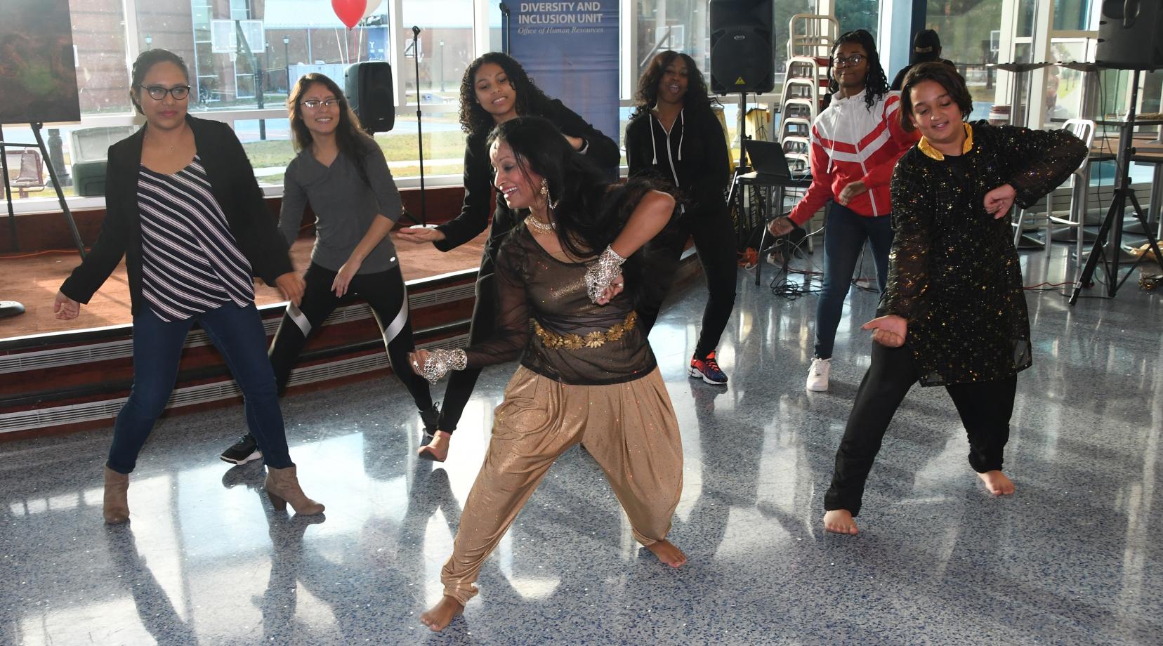 An dancer from Bangladesh teaches some audience participant a dance from her country during the Unity in Diversity event.
