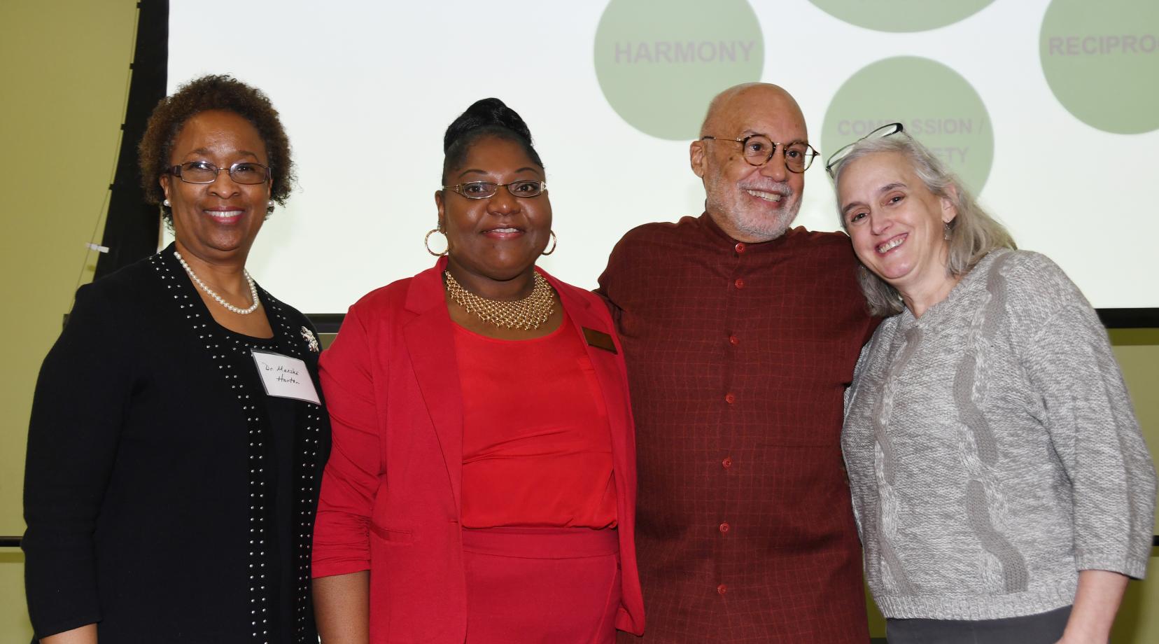 (L-r) Dr. Marsha Horton, dean of the College of Health & Behavioral Sciences, Dr. Gwen Scott-Jones, chair of the Dept. of Psychology, keynote speaker Aminifu R. Harvey, and Del. First Lady Tracey Carney, pose during a Feb. 14 conference entitled "Shifting from Trauma Informed Care to an African Healing Centered Approach."