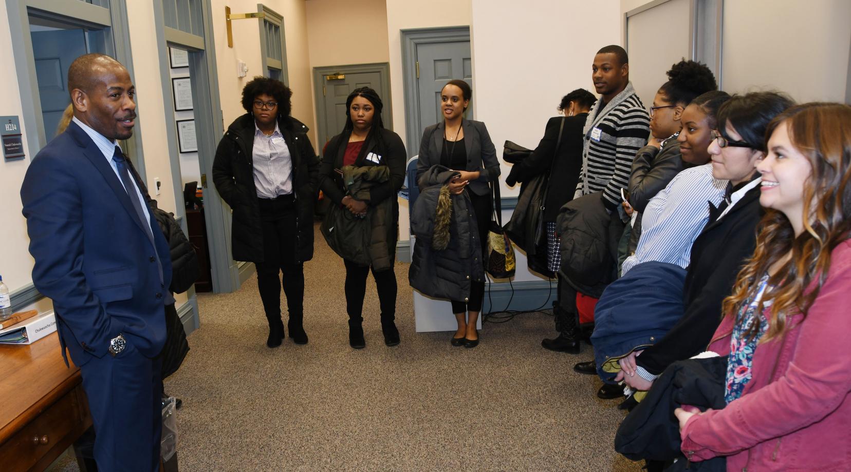 Rep. Nnamdi Chukwuocha, a University alumnus, speaks to a group of DSU social work students outside of his office at Legislative Hall.