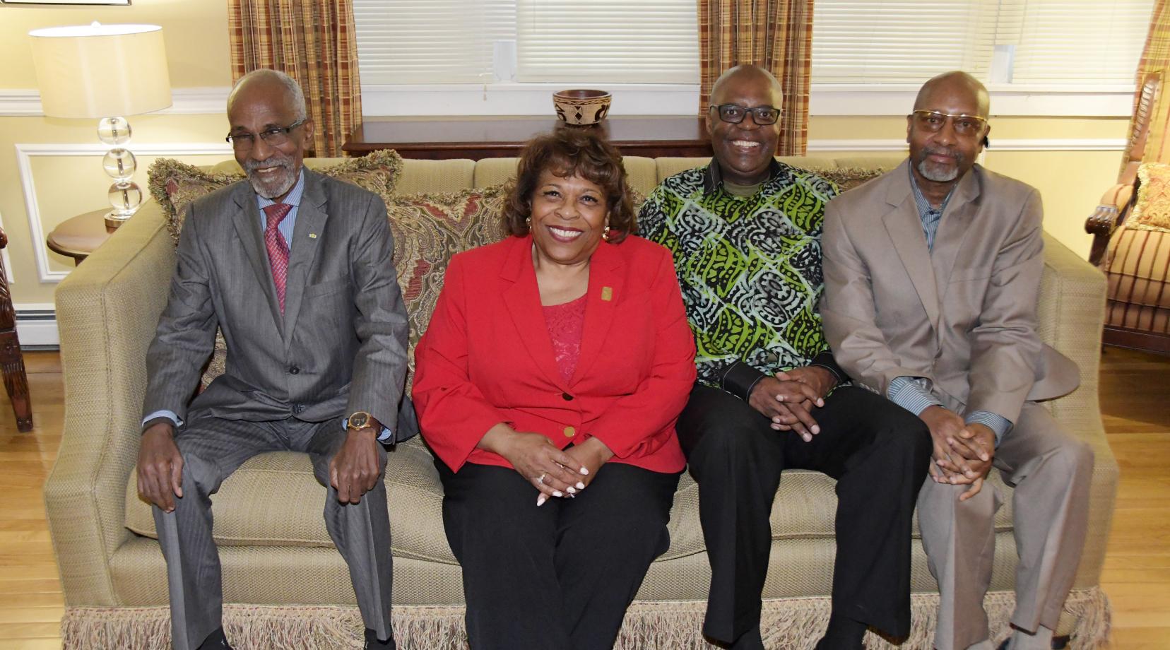 <p>(L-r) APRM Minister Khayar Oumar Defallah, University President Wilma Mishoe, APRM CEO Dr. Eddy Maloka, and Center for Global Africa's Ezrah Aharone, pose together during a April 9 reception at the President's Residence.</p>