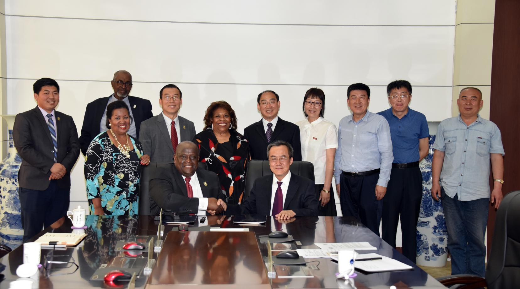 <p>Tony Boyle, Vice President of Strategic Enrollment Management, and JiZong Qi, Vice President of Beihua University of China, shake hands after signing an agreement that establishes a joint English Language Institute in that Far East country.</p>