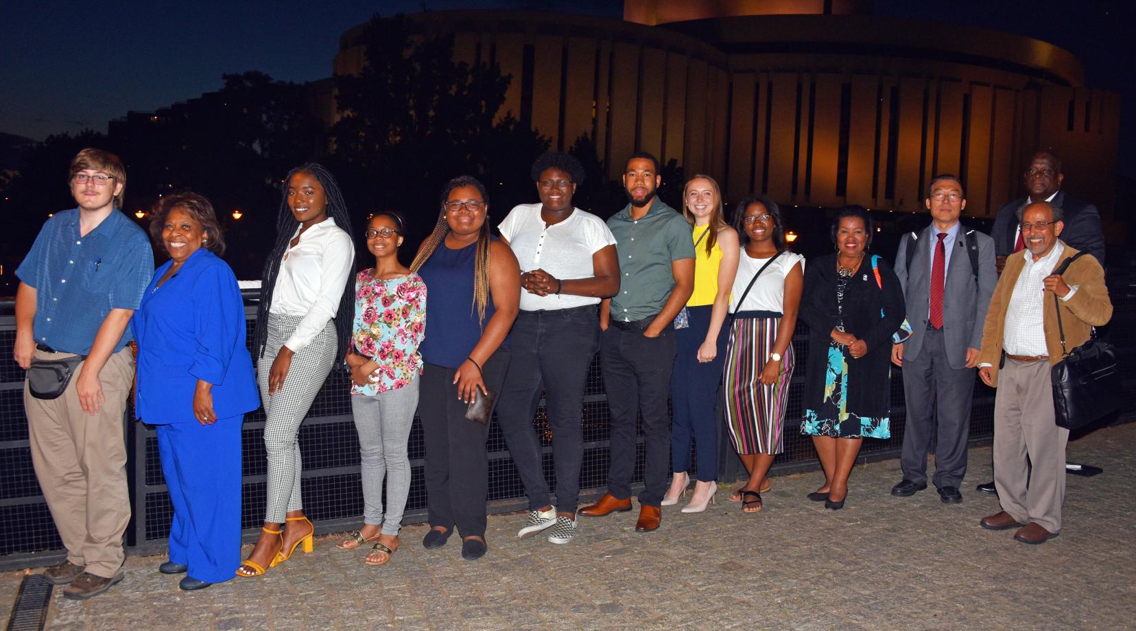 <p>After dinner photo: (l-r) Dominic Morrell, University President Wilma Mishoe, Juliana Paul, Mykia Toney, Destiny King, Kishaye Williams, Corban Weatherspoon, Pamela Schork, Jacori Small, Board of Trustees Chairperson Devona Williams, along with Dr. Fengshan Liu, associate VP of International Affairs, Dr. Mazen Shahin, AMP Director, and Tony Boyle, VP of Strategic Enrollment Management.</p>