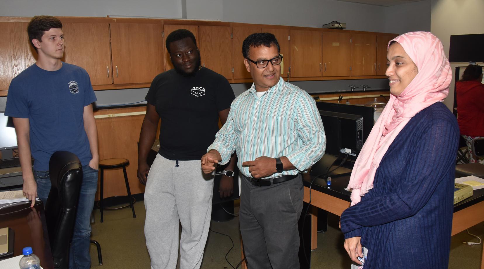 The DoD funded X-ray Diffraction System will not only be used for ongoing and future research project, but also it will be used an advanced technology that science students (like the ones Dr. Mukti Rana is chatting with here) can be exposed to and trained to use.