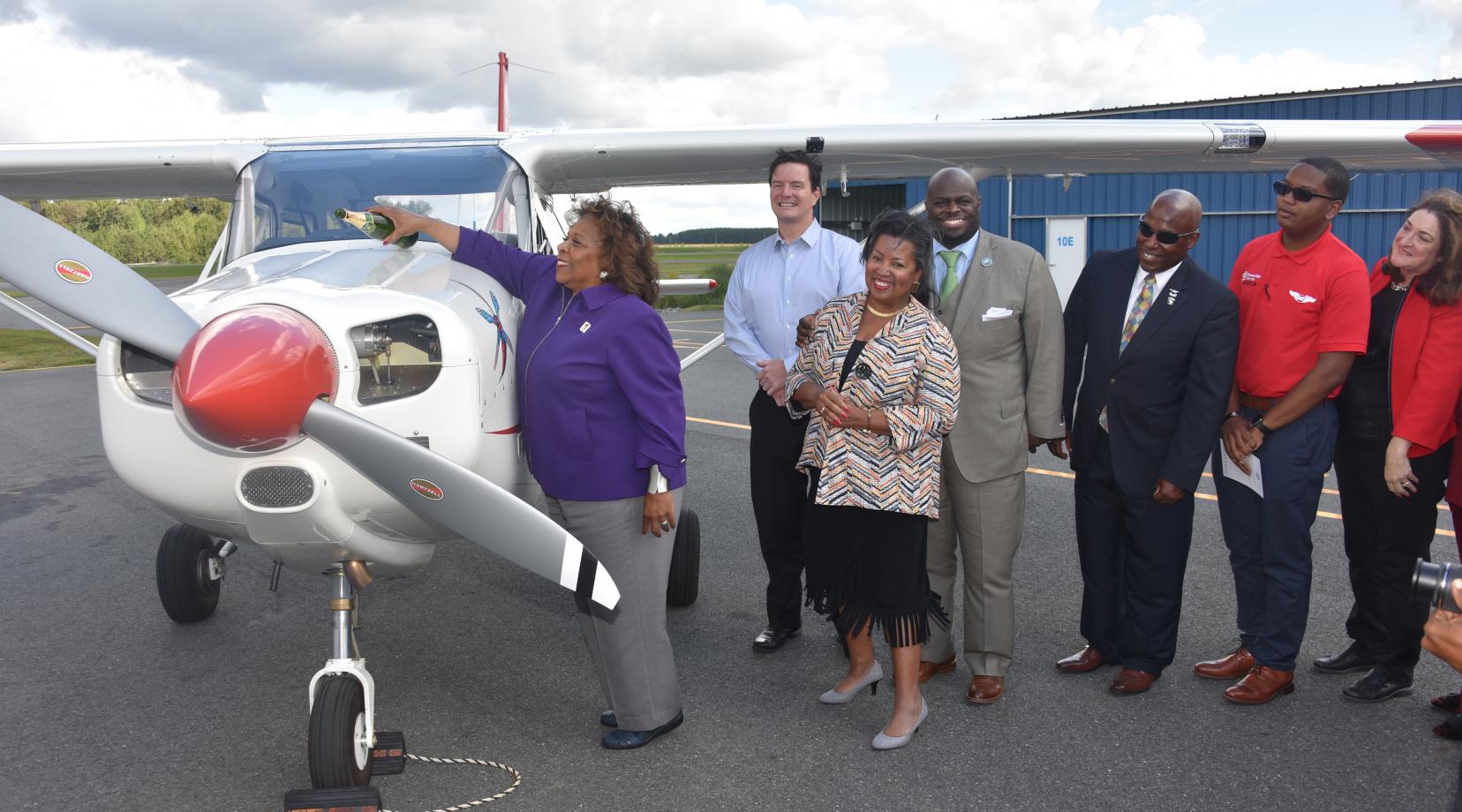 <p>University President Wilma Mishoe christens the Aviation Program's newest aircraft, which is the first of a new 11-plane fleet that slated to be delivered soon.</p>