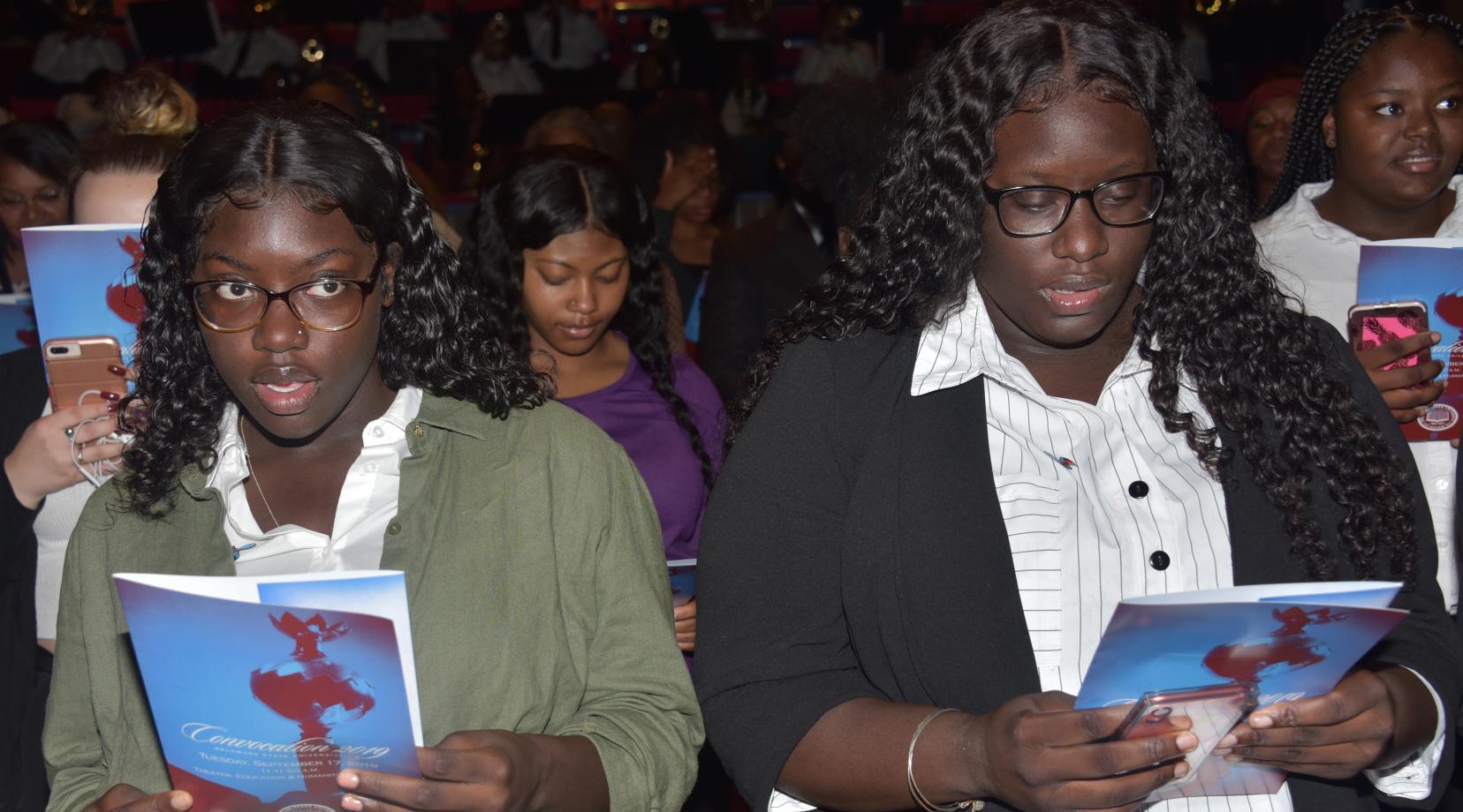 Two freshmen sing the University's Alma Mater at the end of the Sept. 19 Convocation Ceremony