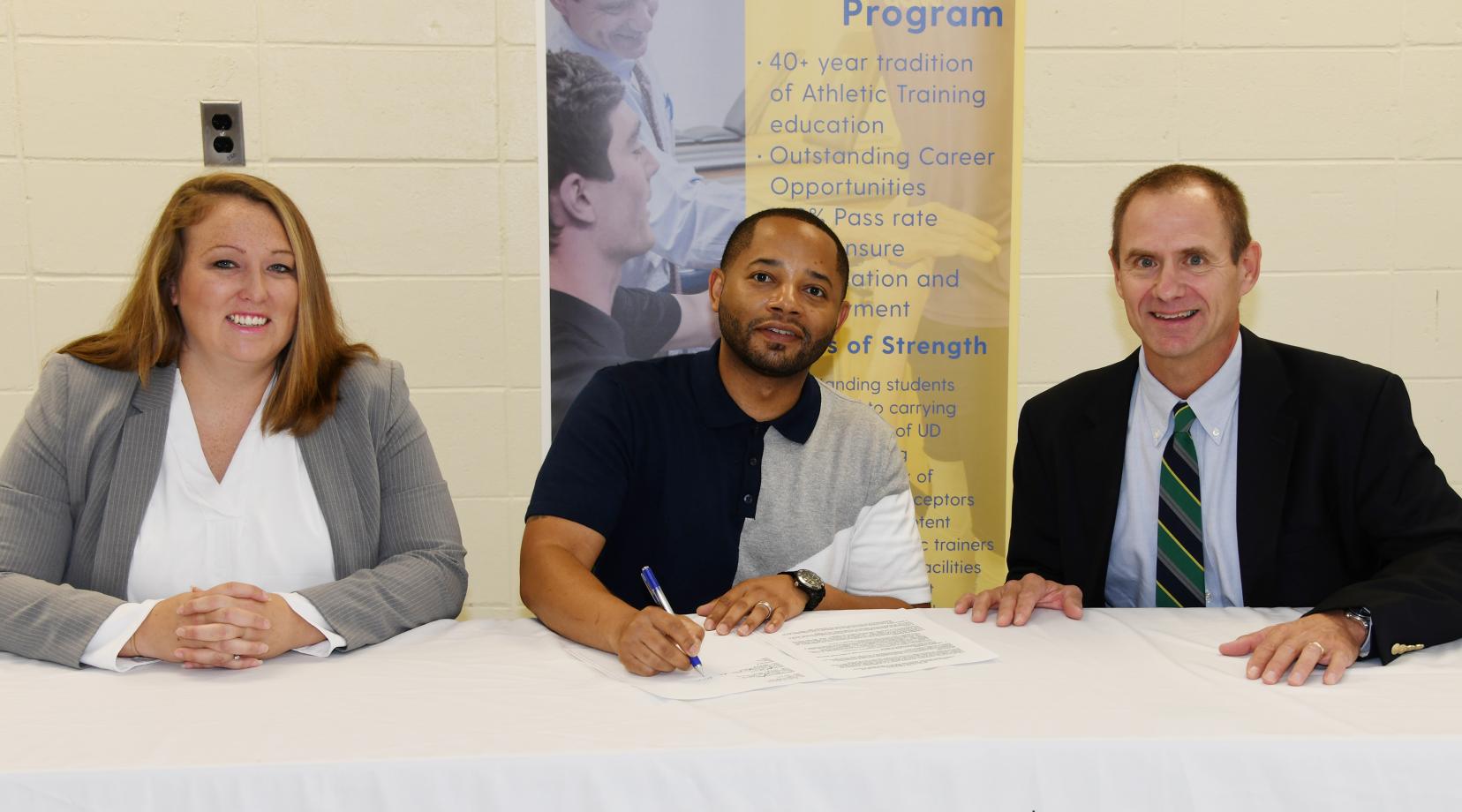 <p>Delaware State University's Dr. Cara Gomez and Dr. R. Christopher Mason join UD's Dr. Thomas Kaminski in signing an agreement that will create a pipeline for kinesiology students to enroll in UD's Athletic Training Master's Degree Program.</p>