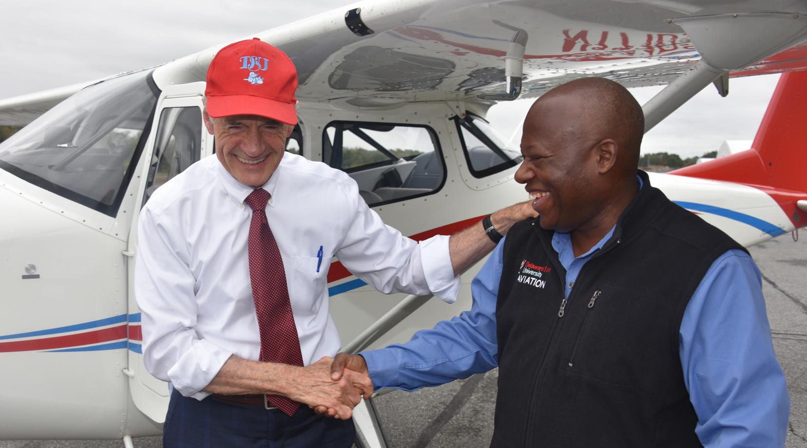 U.S. Sen. Tom Carper shakes hands with Lt. Col. Michael Hales, director of the University's Aviation Program, after the elected official flew one of the new planes recently acquired by Del State. Sen. Carper is a former naval aviator.