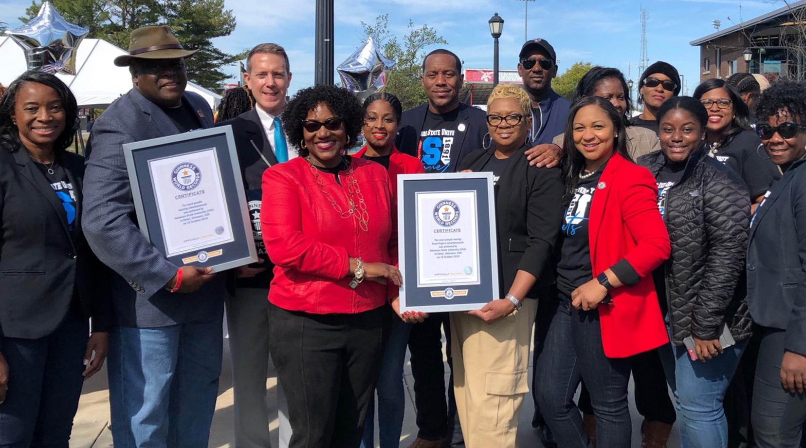 Participants celebrate the setting of two Guinness World Records titles for "The Most People Waving Foam Fingers Simultaneously" and "The Most People Buzzing Simultaneously," which took place at the University's Oct. 19 Open House.