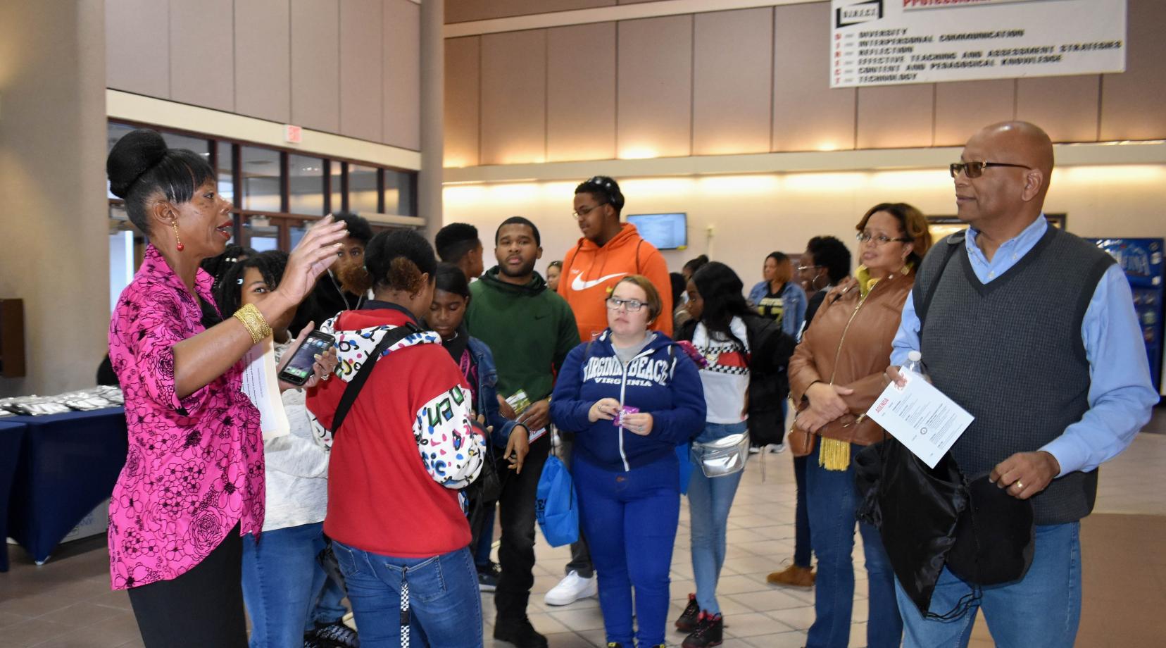 Brenda Farmer, executive director of Ceremonies and Events, gives instructions to the families attended Parents Day.