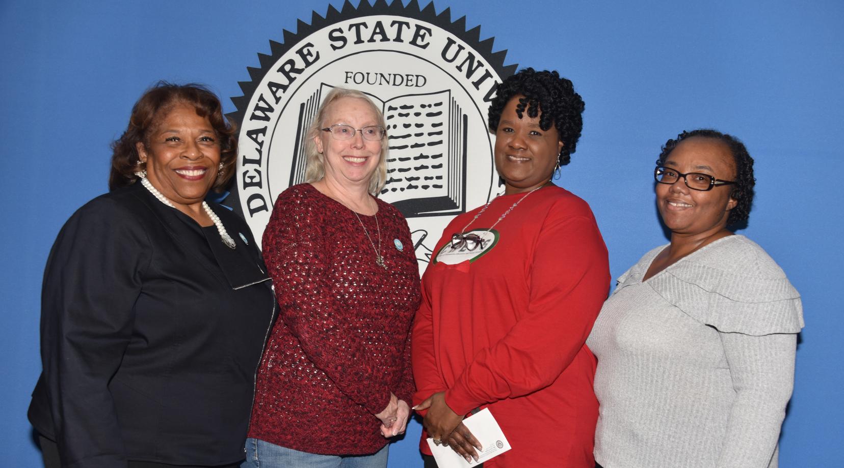University President Wilma Mishoe stands with the 2019 Outstanding Service Award recipients.