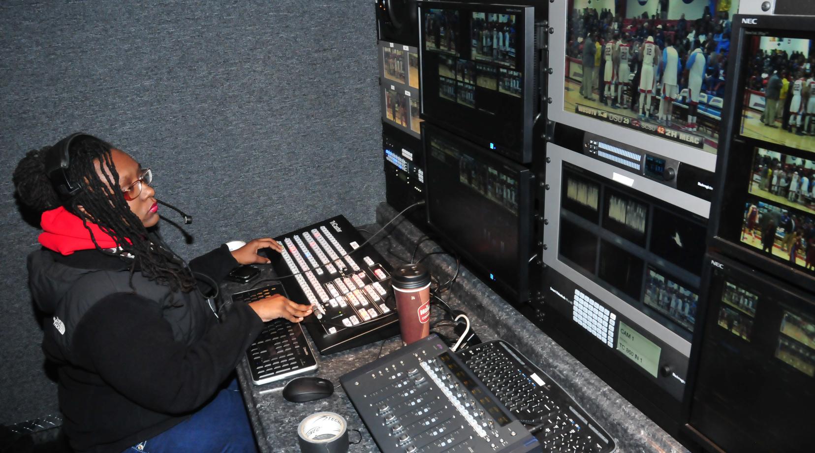 Jasmine Alford works a Hornet basketball game in the Mobile Video Production Trailer. The production trailer has reduced the set-up time for the students and provided them with an excellent hand-on experience environment.
