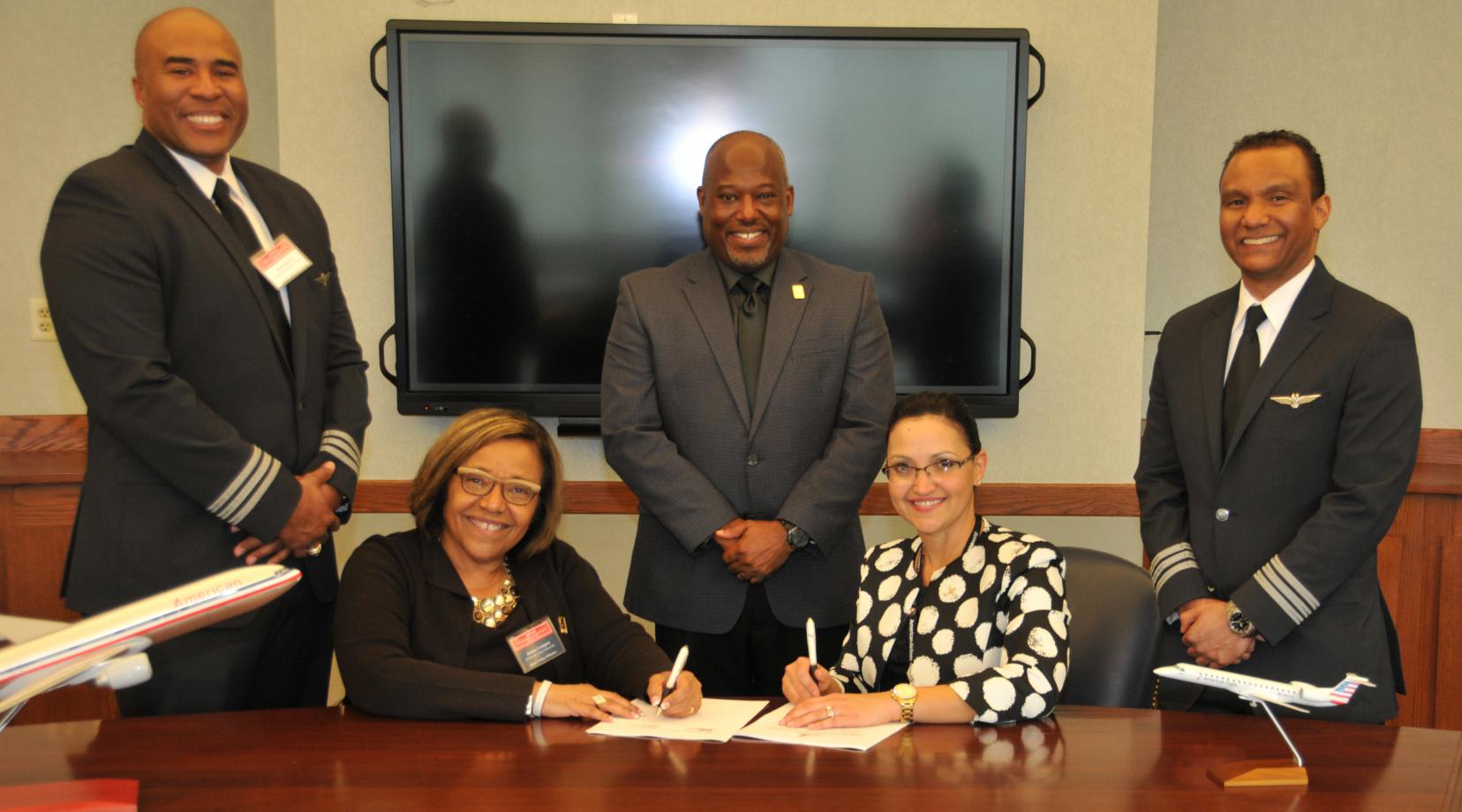 <p>(Seated l-r) DSU College of Business Dean Donna Covington and Lynette Darnell, Piedmont Cadet Program manager.</p>
<p>(Standing l-r) First Officer Robert Barkers of American Airlines; Lt. Col. Michael Hales, director of the DSU Aviation Program; and First Officer Antonio Verges of American Airlines</p>