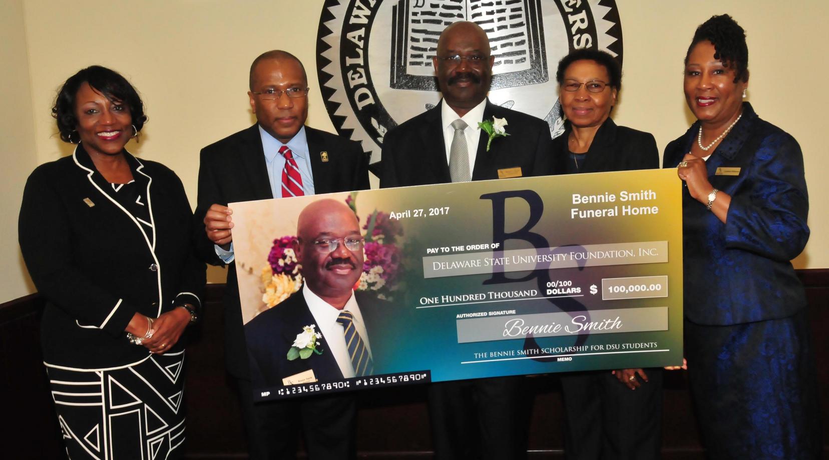 (L-r) Dr. Vita Pickrum, DSU President Harry L. Williams, Bennie and Shirley Smith, as well as Cynthia Williams of Bennie Smith Funeral Homes, pose with a display check representing the newly established endowment.