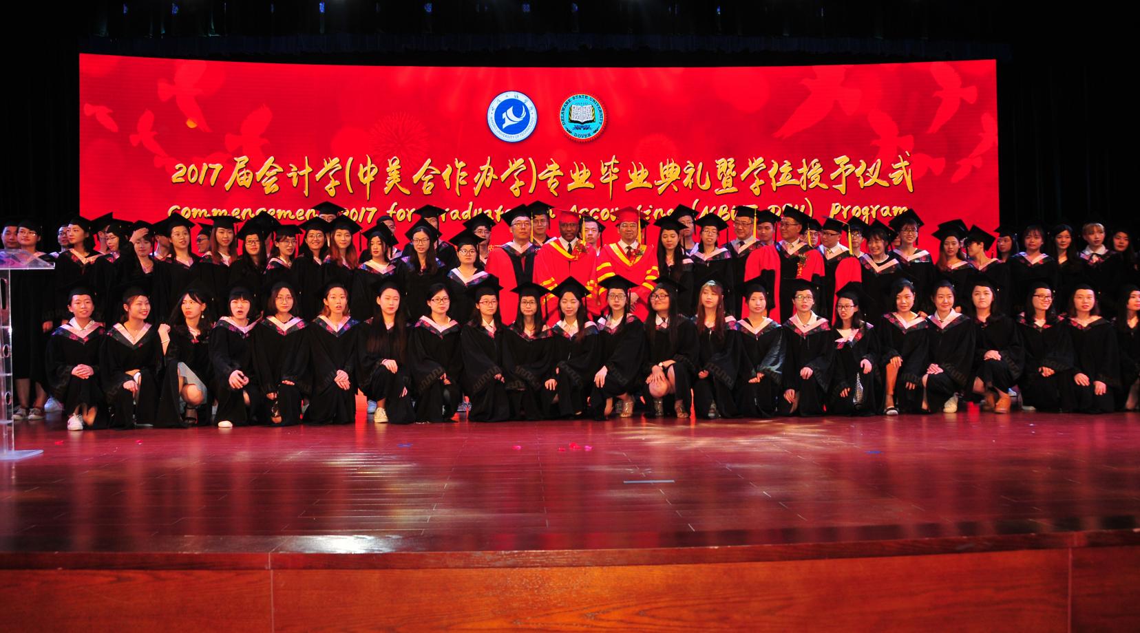 <p>(Center) Dr. Fengshan Liu, DSU President Harry L. Williams and NBUT President Lyn Zhongda pose with the 81-member class of graduates from the DSU-NBUT Accounting Program</p>