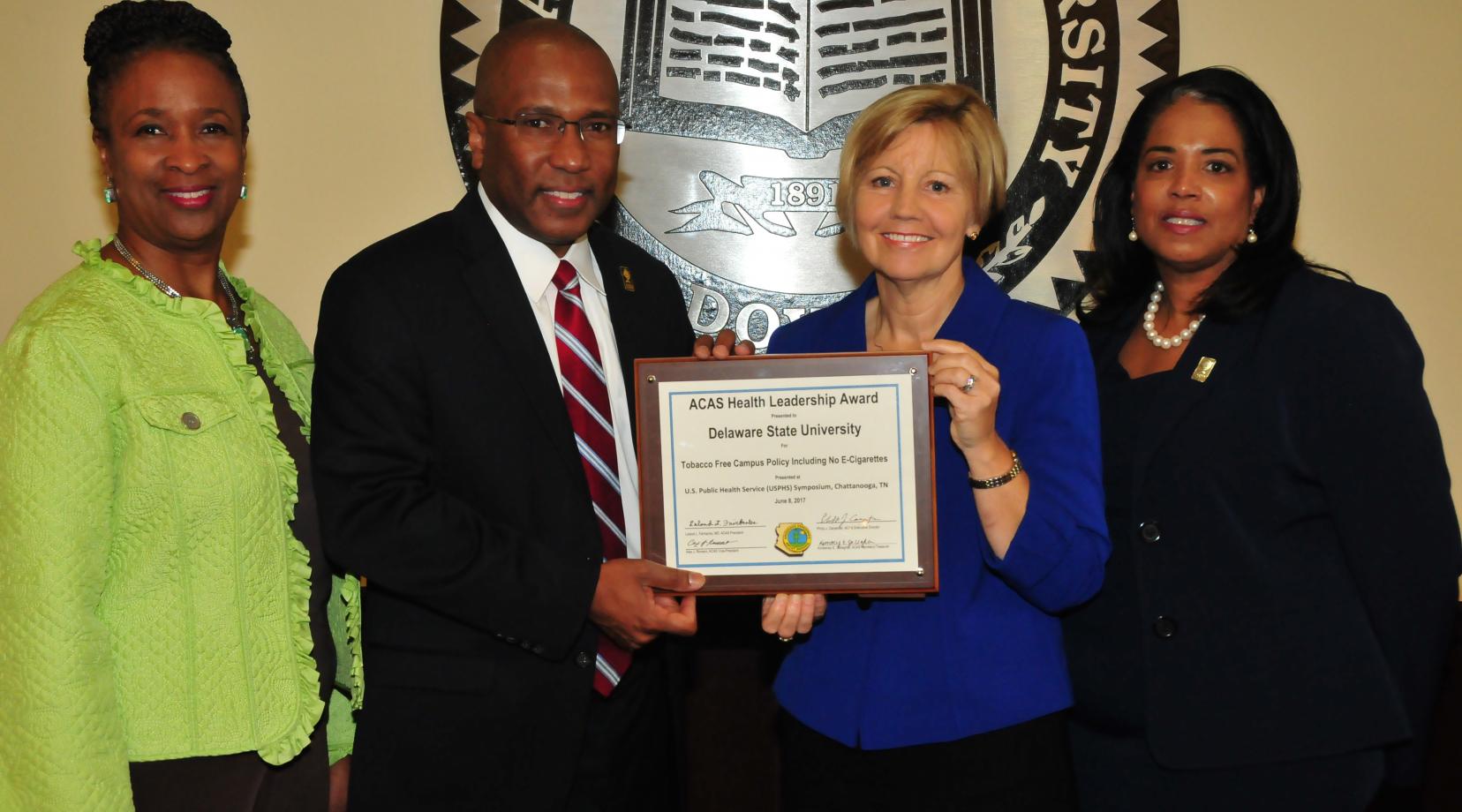 (L-r) Dr. Marsha Horton, dean of the College of Education, Health and Public Policy; DSU President Harry L. Williams; Marianne Carter, director of the Del. Center for Health Promotions; Dr. Michelle Fisher, director of DSU Health Service, display the national award DSU received for its no smoking policy on campus.