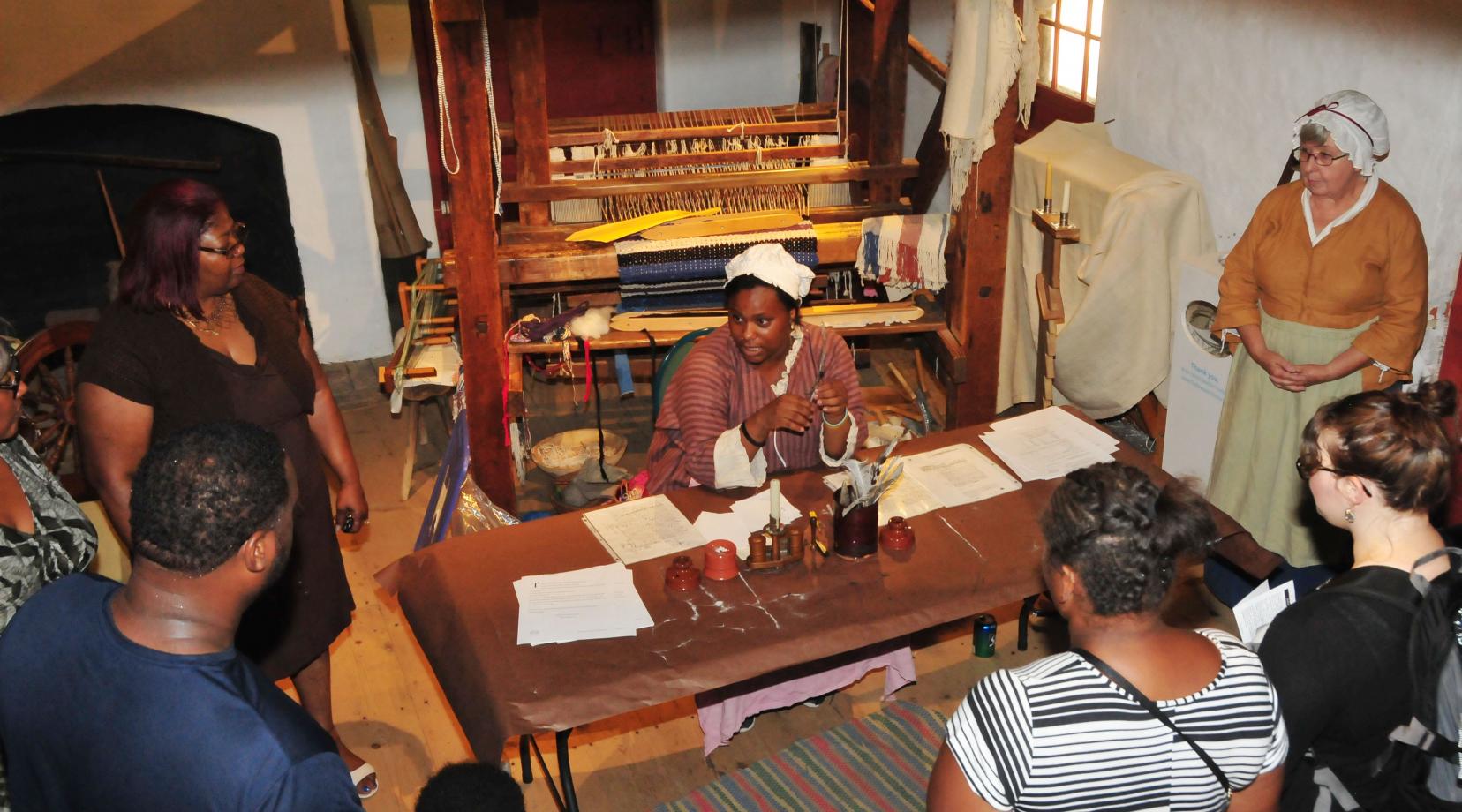 <p>Armani McCoy explains the use of the quail pen during the 1700s to visitors at the John Dickinson Plantation.</p>