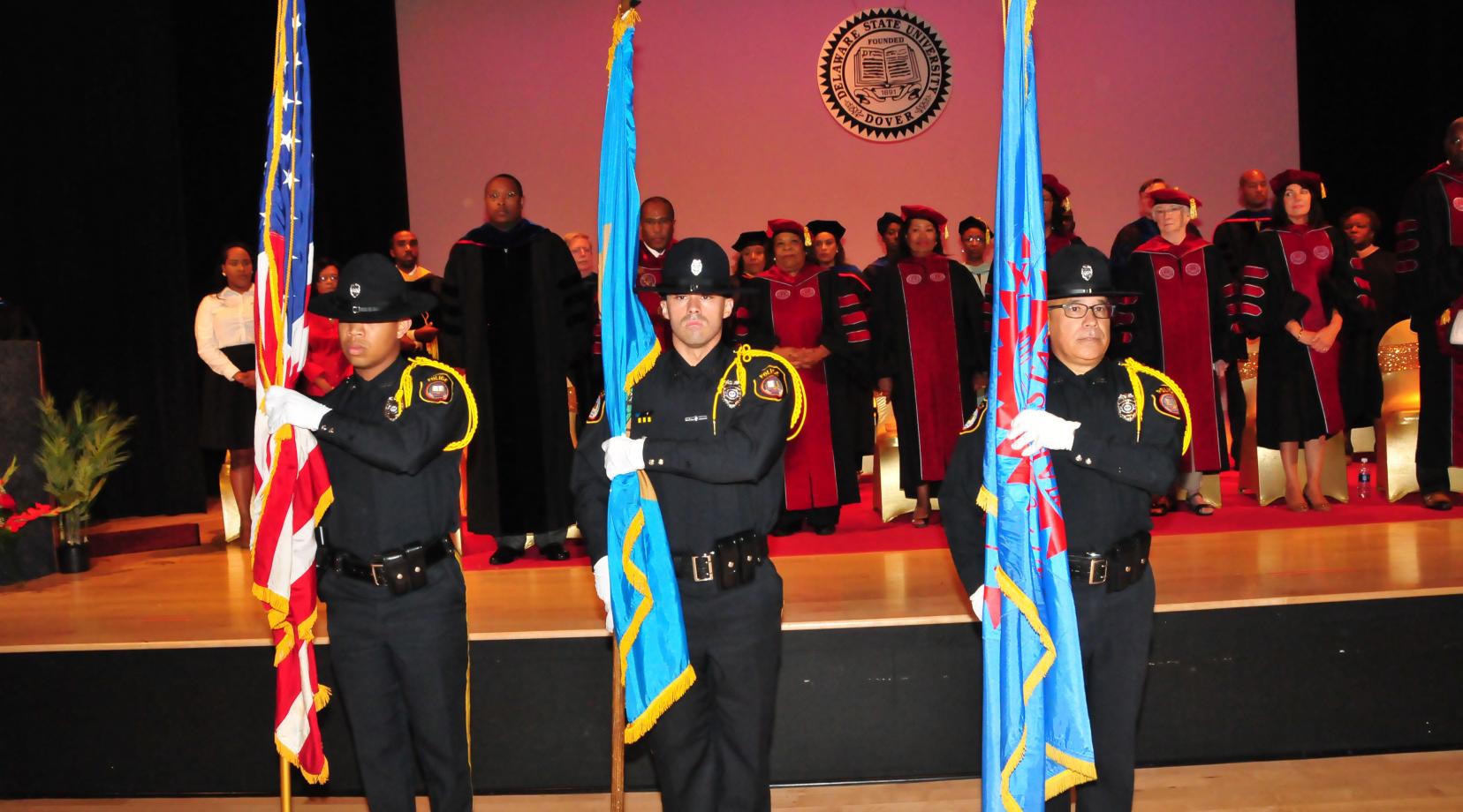 The DSU Police Honor Guard -- (l-r) Ptlm. Teddy Tyson, Ptlm. Anthony Sapienza and Ptlm. Jorge Camacho -- present the flags for the opening National Anthem during the Convocation Ceremony.