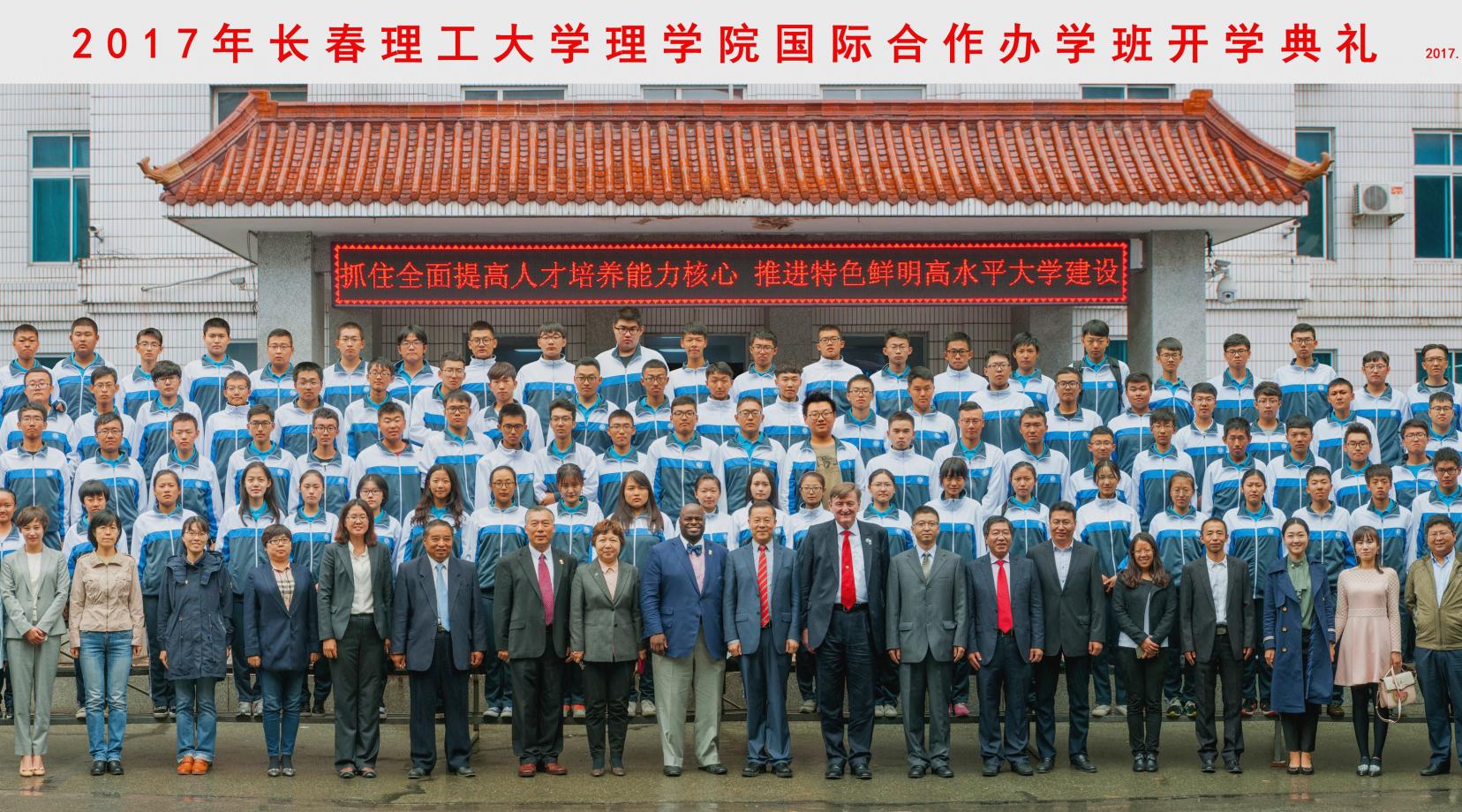 Drs. Fengshan Liu, Tony Allen and Bradley Skelcher stand with officials from Chanchung University of Science and Technology and a large group of its students who were attending a new student orientation day at that institution.