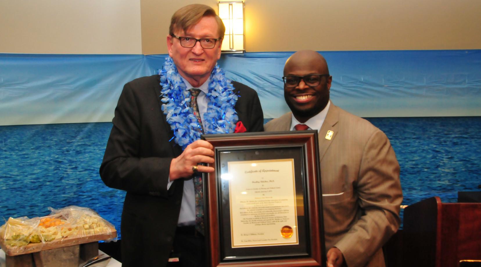 Dr. Bradley Skelcher (l) receives the University's title of "Professor Emeritus" from Provost Tony Allen.