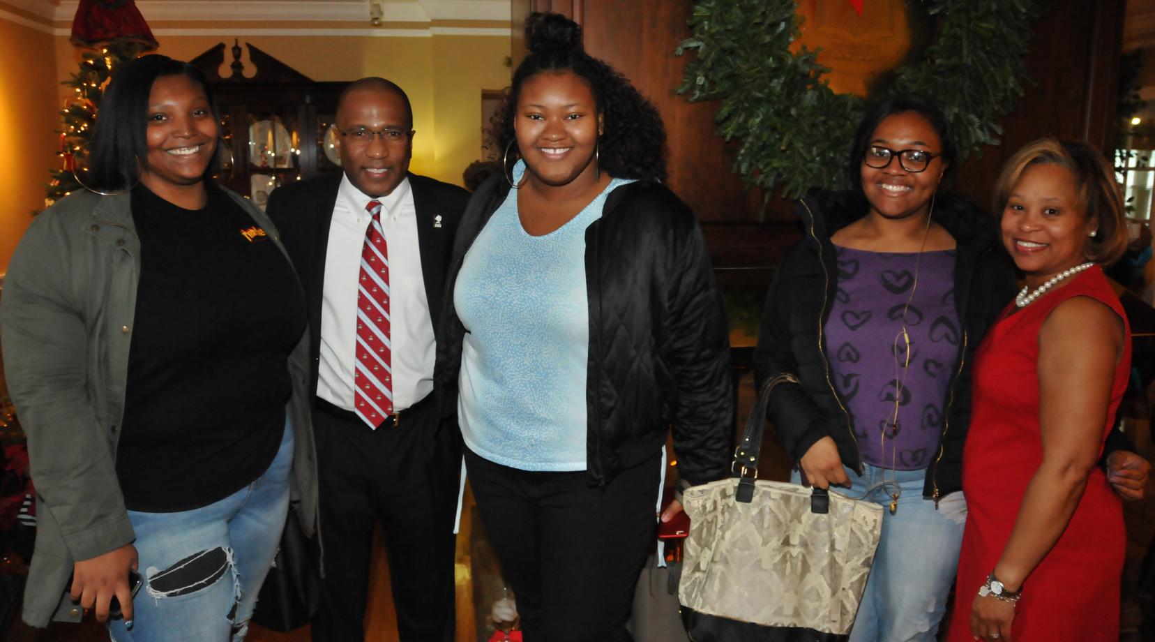 DSU President Harry L. Williams and First Lady Dr. Robin Williams pose with a group DSU students during their Christmas celebration at their residence.