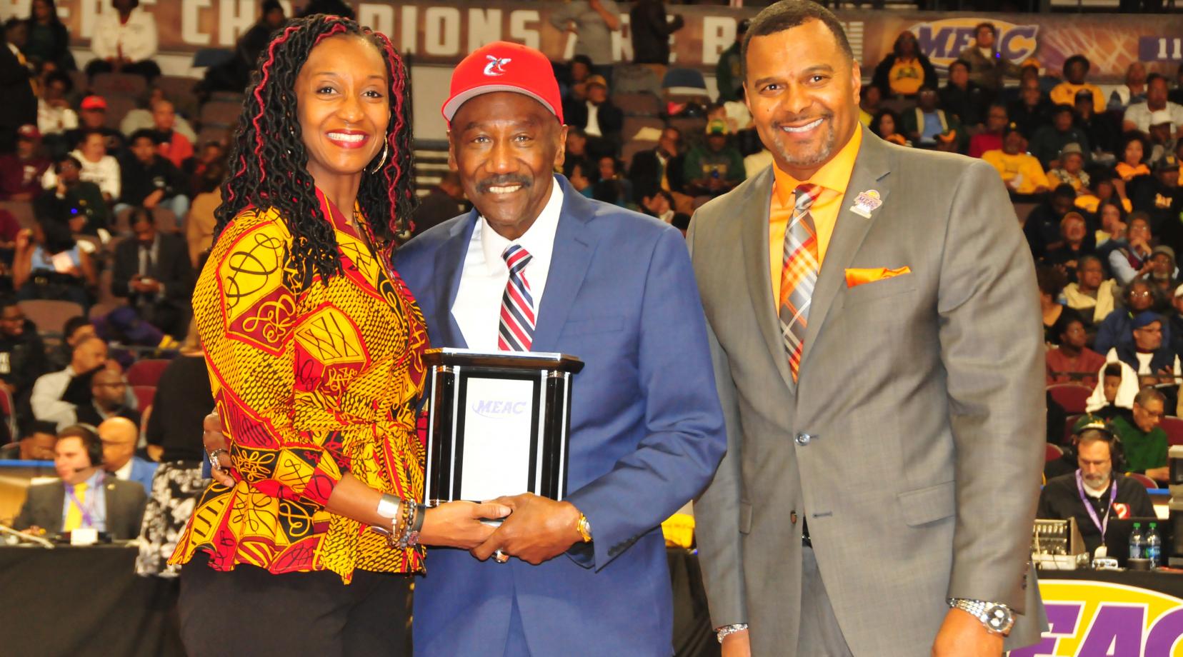 Robert P. Vanderhost (center), DSC class of 1972, was among the 2018 MEAC Alumni of the Year. He is shown March 8 at the MEAC Basketball Tourney accepting the award from two conference officials.