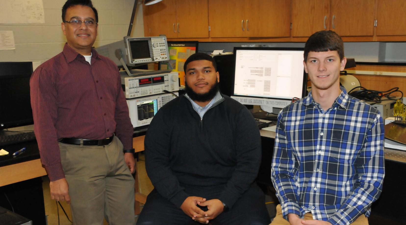 <p>(L-r) Dr. Mukti Rana, chair of the Dept. of Physics and Engineering and the grant's principal investigator, with Danzel Hill and Andrew Voshell, undergraduate and graduate students, respectively. Both students are working with Dr. Rana on the research project.</p>