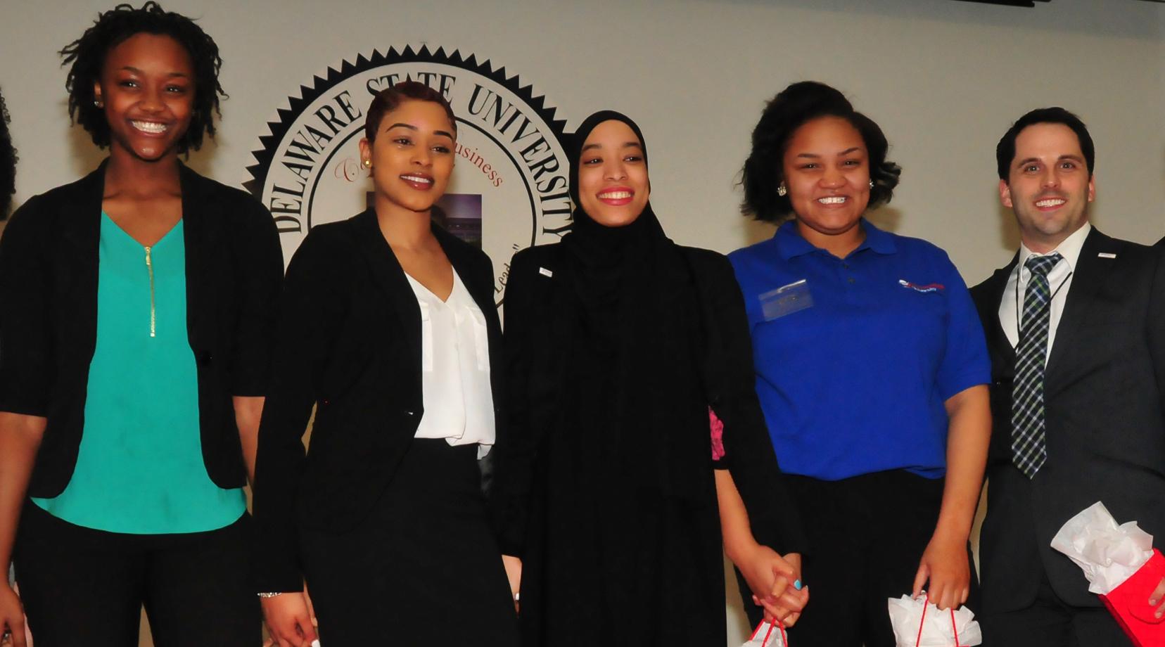 <p>The Business Competition first-place En'Liven team: (l-r) Lashae Eden-Clemons, LaShae Billips, Alexis Sharif, Kia Abrams, along with their coach Brian Passerell. The team came up with the best plan to address homelessness.</p>