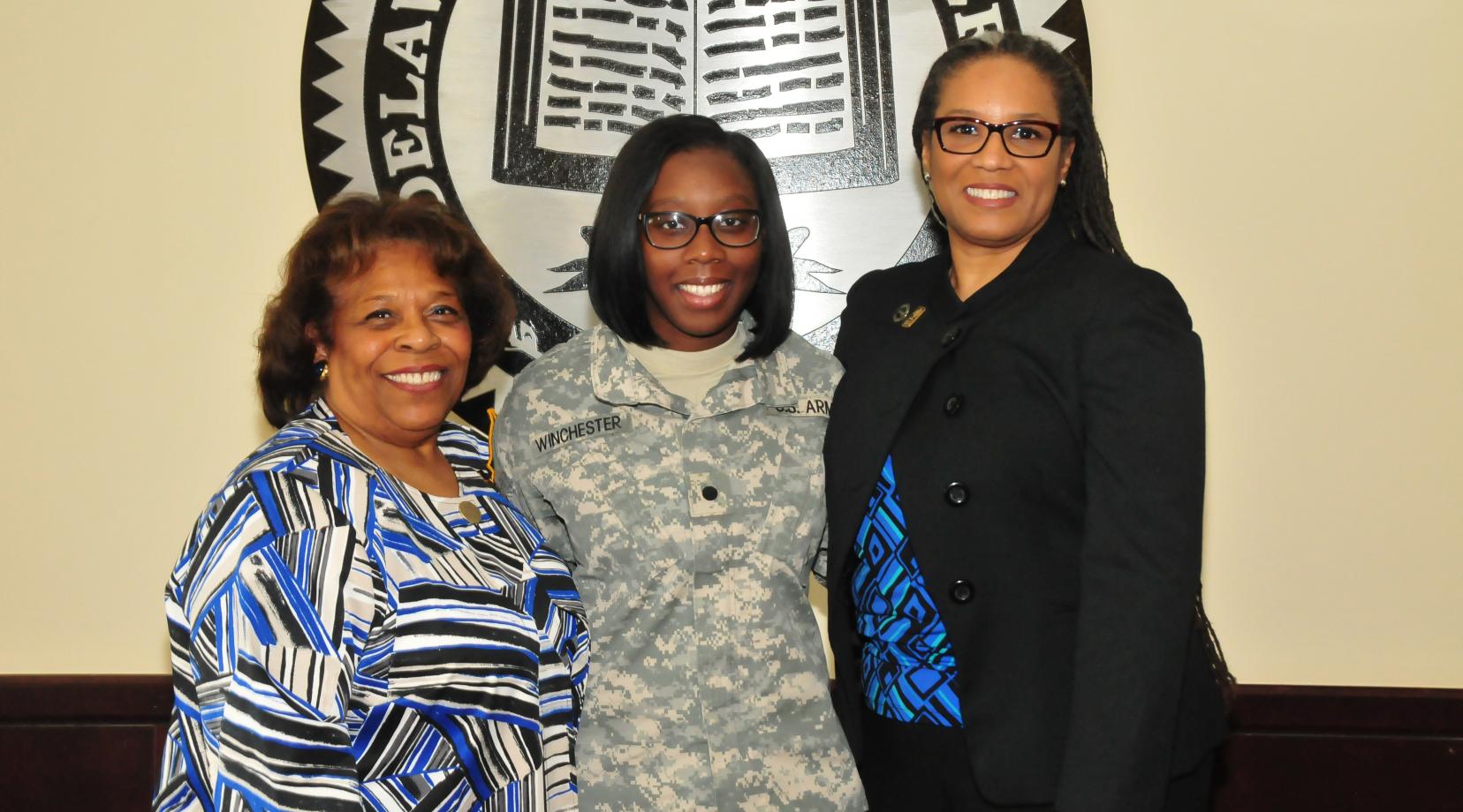 <p>Alisa Winchester (center), a junior English major, stands with DSU Acting President Wilma Mishoe (l) and Dr. Adenike Davidson, professor of English. Just before the photo, Dr. Mishoe informed Ms. Winchester, also a ROTC cadet, that she has been awarded the prestigious Harry W. Truman Scholarship.</p>