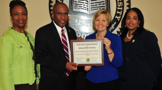 <p>(L-r) Dr. Marsha Horton, dean of the College of Education, Health and Public Policy; DSU President Harry L. Williams; Marianne Carter, director of the Del. Center for Health Promotions; Dr. Michelle Fisher, director of DSU Health Service, display the national award DSU received for its no smoking policy on campus.</p>