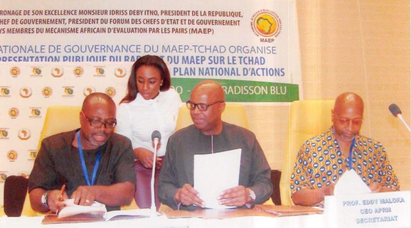<p>(L-r seated) DSU's Dr. Akwasi Osei, associate dean of the College of Humanities, Education and Social Sciences, Dr. Eddy Maloka, CEO OF APRM, and Ezrah Aharone, DSU adjunct associate professor of history and political science, sign the partnership document in the African country of Chad, while an identified woman assists them.</p>