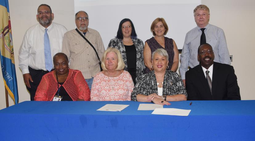 <p>(Seated l-r) FSCAA's Bernice Edwards, exec. director, and Dr. Anne Farley, board president; DSU's Dr. Patrice Gilliam-Johnson, dean of Graduate, Adult and Extended Studies, and Dr. Darren Blackston, <a href="mailto:DSU@Georgetown">DSU@Georgetown</a> director. (Standing) FSCAA officials Bruce Wright, Cagney J. France and Jaime Sayler; DSU's Lisa Perelli; and Brad Whaley of the Sussex County Office of Community Development pose after the signing.</p>