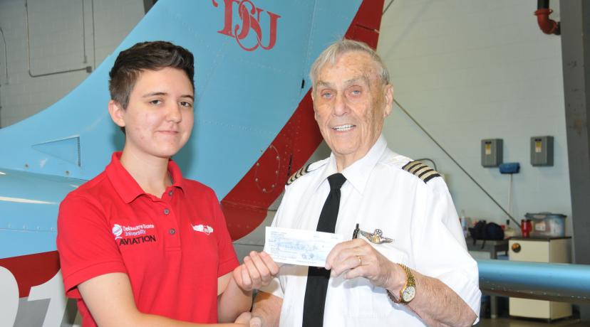 <p>Dr. Daniel E. Coons, shown last fall presenting a scholarship check to aviation major Rebekah Goebels, passed away on May 3 after a battling cancer for several years.</p>