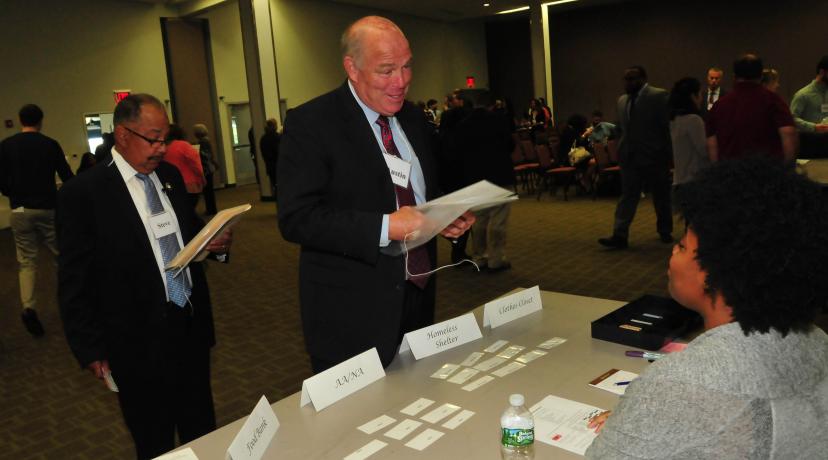 <p>(L-r) State Rep. James Johnson and state Speaker of the House Peter Schwartzkopf visit a "homeless shelter" operated by a DSU student as part of Re-Entry Simulation event held in the MLK Jr. Student Center.</p>